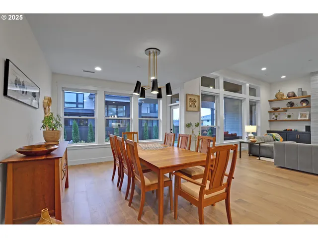a dining room with furniture and wooden floor