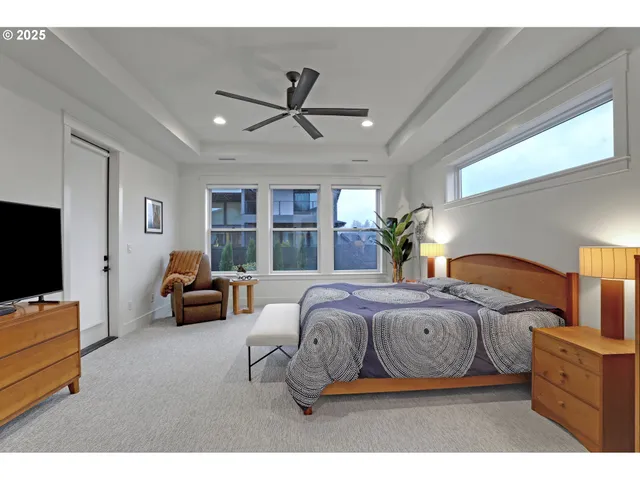 a bedroom with furniture and a flat screen tv