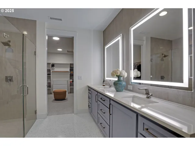 a bathroom with a double vanity sink and mirror