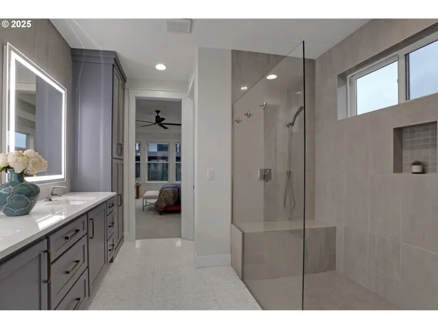 a bathroom with a sink a shower and a mirror
