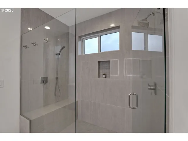 a bathroom with a glass shower door