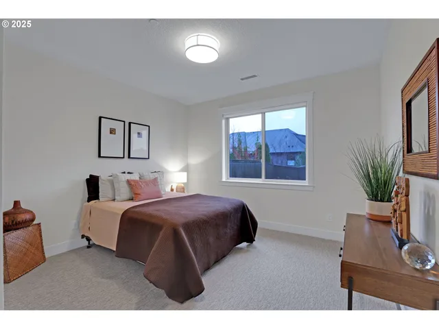 a bedroom with a large bed and a window