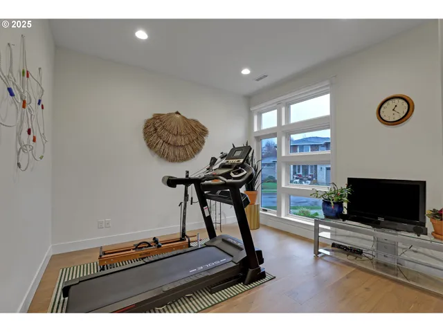 a room with gym equipment and a flat screen tv