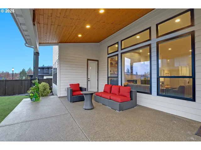 a living room with furniture and a floor to ceiling window