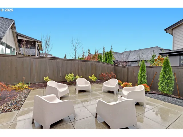 a view of a patio with a table and chairs and potted plants