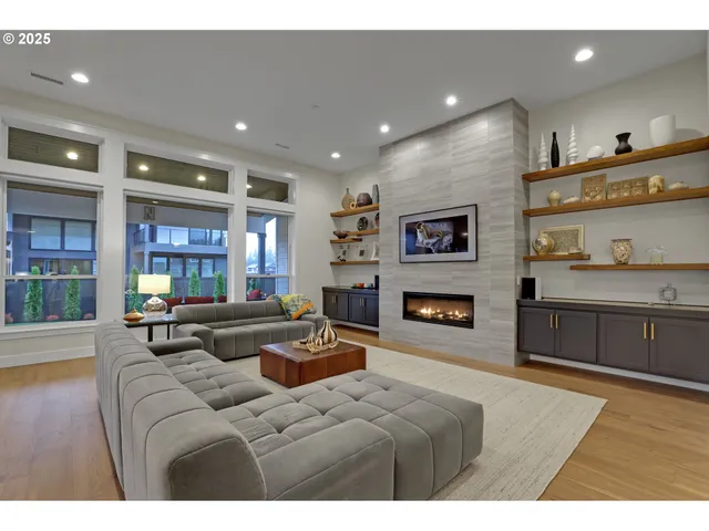 a living room with fireplace furniture and a large window