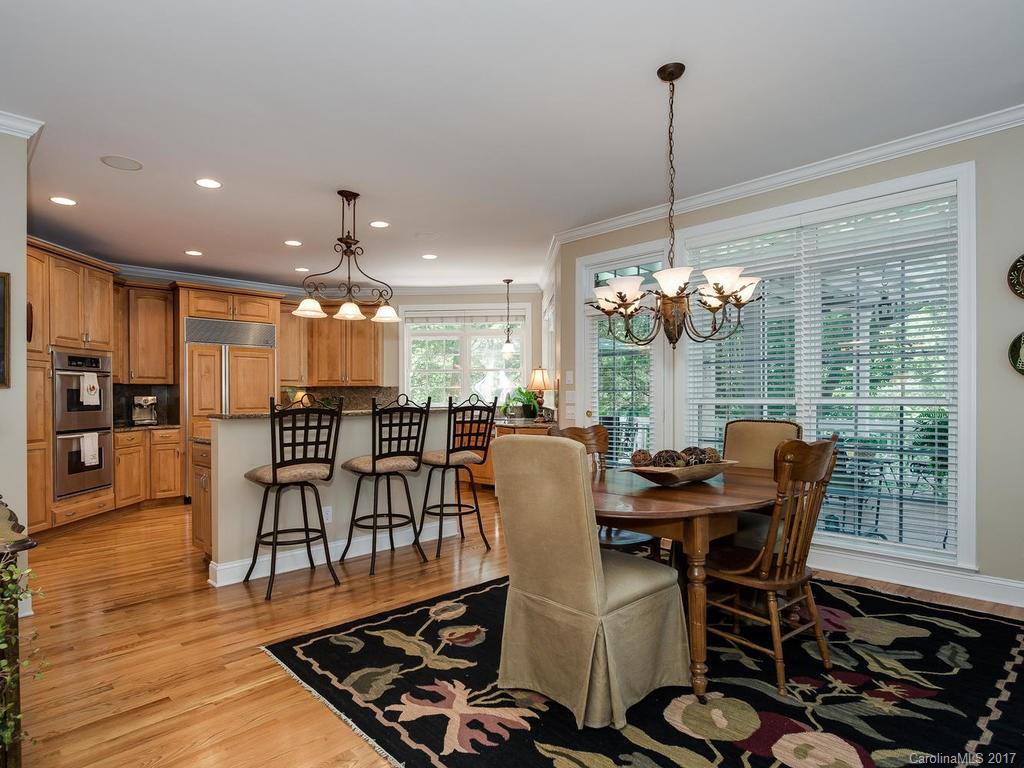 3247 Planters Ridge Road Charlotte, NC 28270 - Photo 11 of 24 a dining room with furniture a chandelier and wooden floor