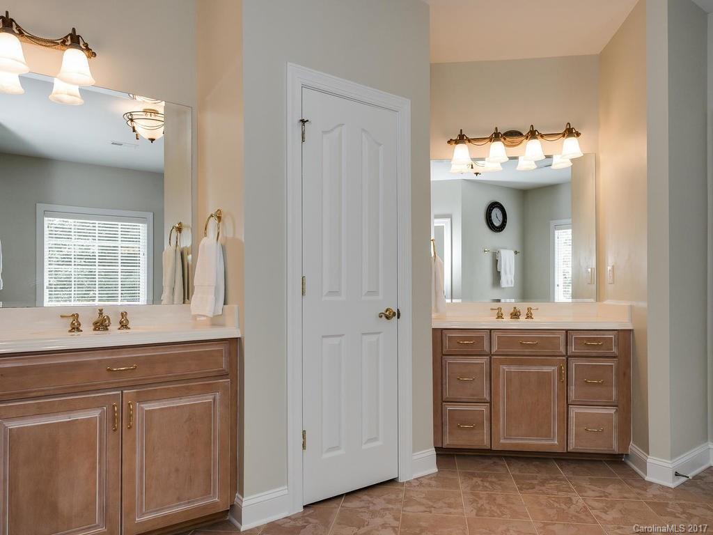 3247 Planters Ridge Road Charlotte, NC 28270 - Photo 15 of 24 a bathroom with a sink and mirror with shower