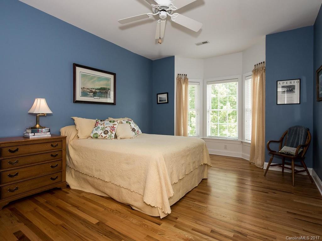 3247 Planters Ridge Road Charlotte, NC 28270 - Photo 17 of 24 a bedroom with a bed and a chandelier