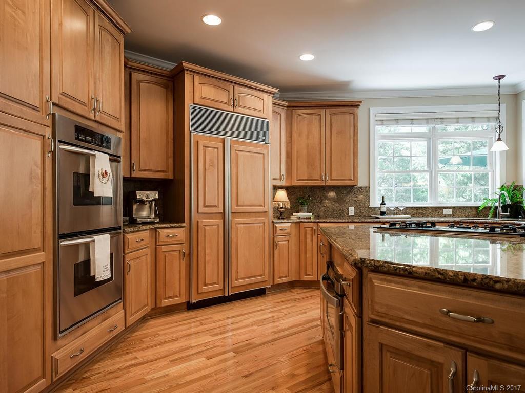 3247 Planters Ridge Road Charlotte, NC 28270 - Photo 8 of 24 a kitchen with stainless steel appliances granite countertop a refrigerator a sink and white cabinets