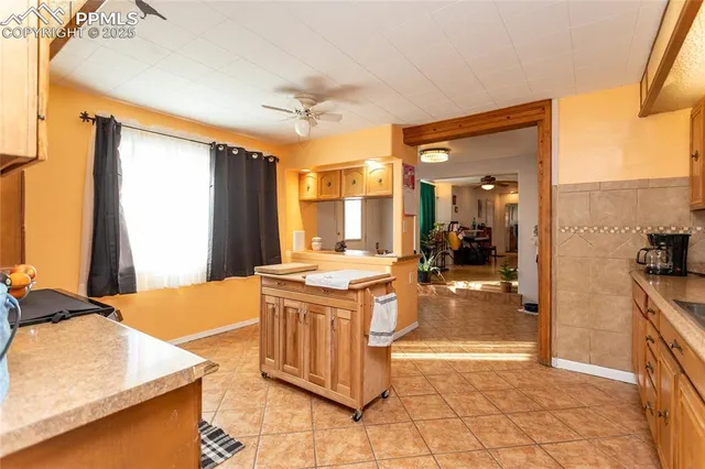 a kitchen with a stove a faucet and a refrigerator
