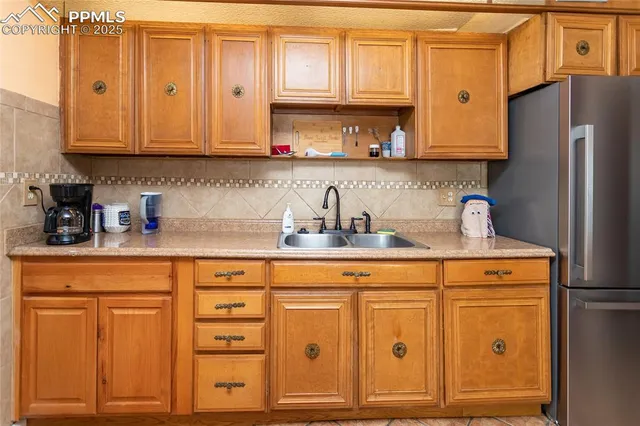 a kitchen with stainless steel appliances granite countertop a refrigerator and cabinets