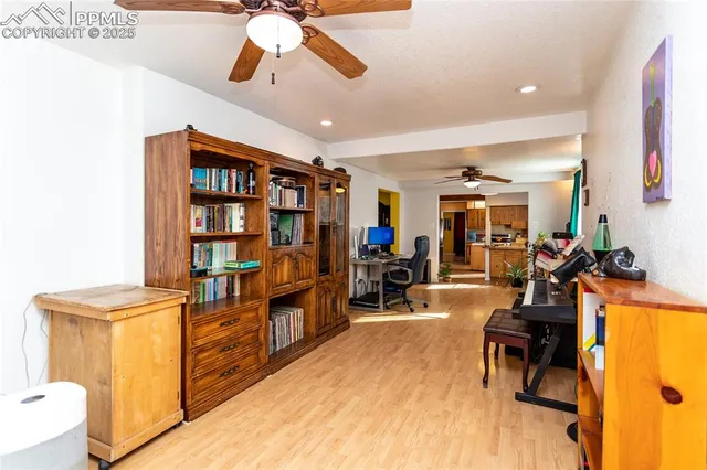 a view of a hallway with wooden floor and a potted plant