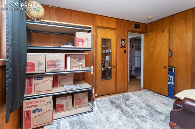 a living room with furniture a window and gym equipment