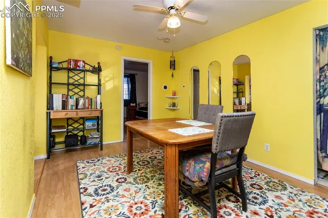 a view of a dining room with furniture and a chandelier