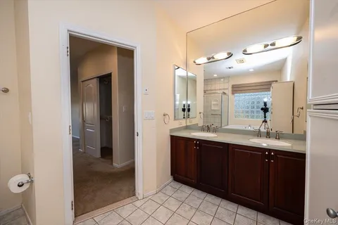a bathroom with a double vanity sink and a mirror