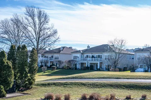 a view of a house with a swimming pool and a yard