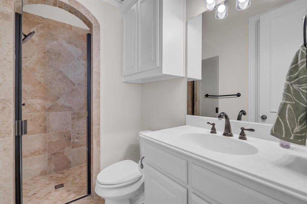 960 Packsaddle Trail Prosper, TX 75078 - Photo 18 of 40 a bathroom with a sink a toilet and shower