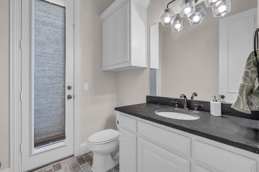 960 Packsaddle Trail Prosper, TX 75078 - Photo 19 of 40 a bathroom with a sink a toilet and a mirror