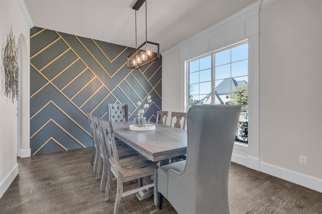 960 Packsaddle Trail Prosper, TX 75078 - Photo 7 of 40 a view of a dining room with furniture wooden floor and chandelier