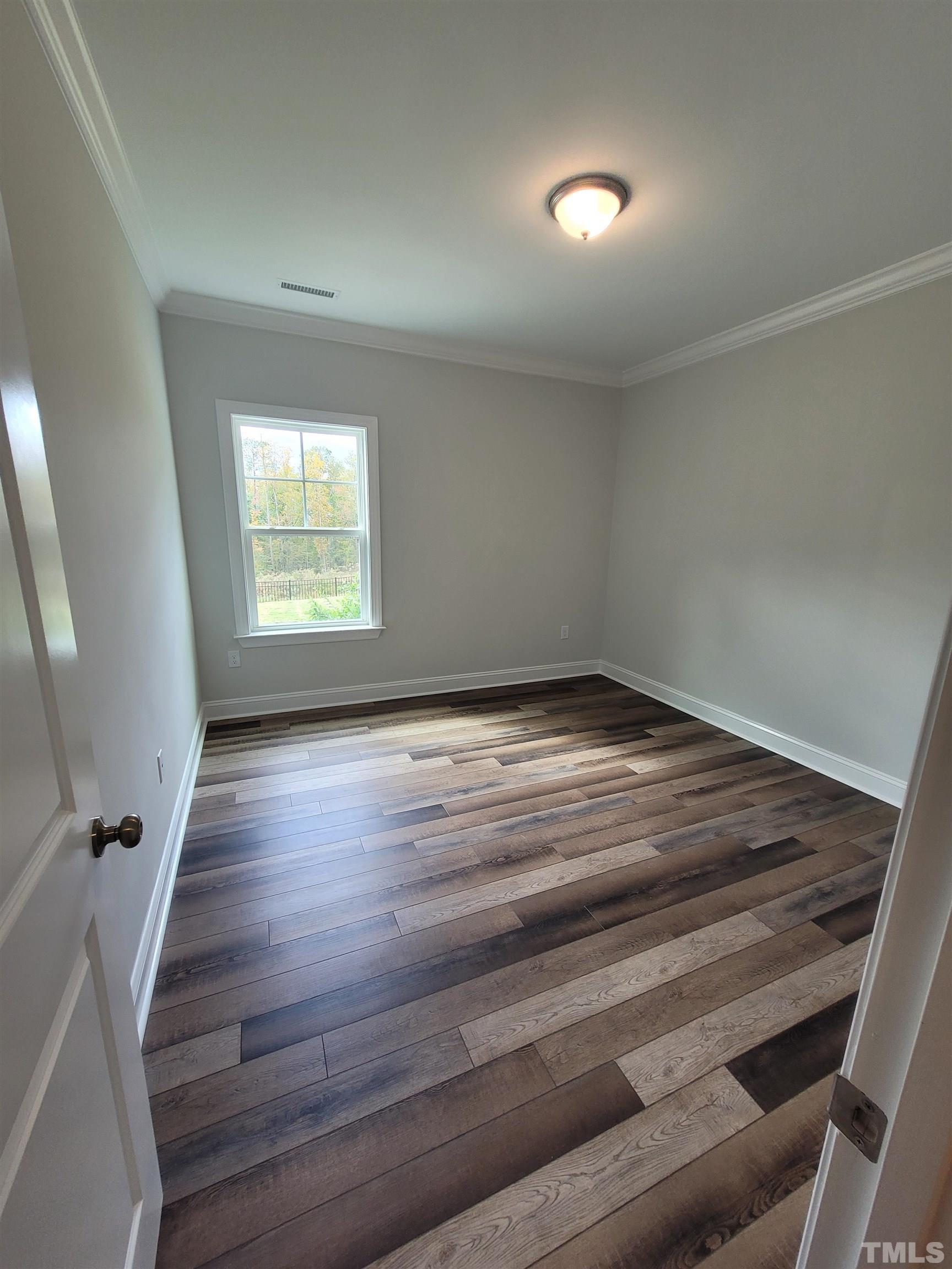 124 Trailing Bluff Way Garner, NC 27529 - Photo 11 of 21 wooden floor in an empty room with a window