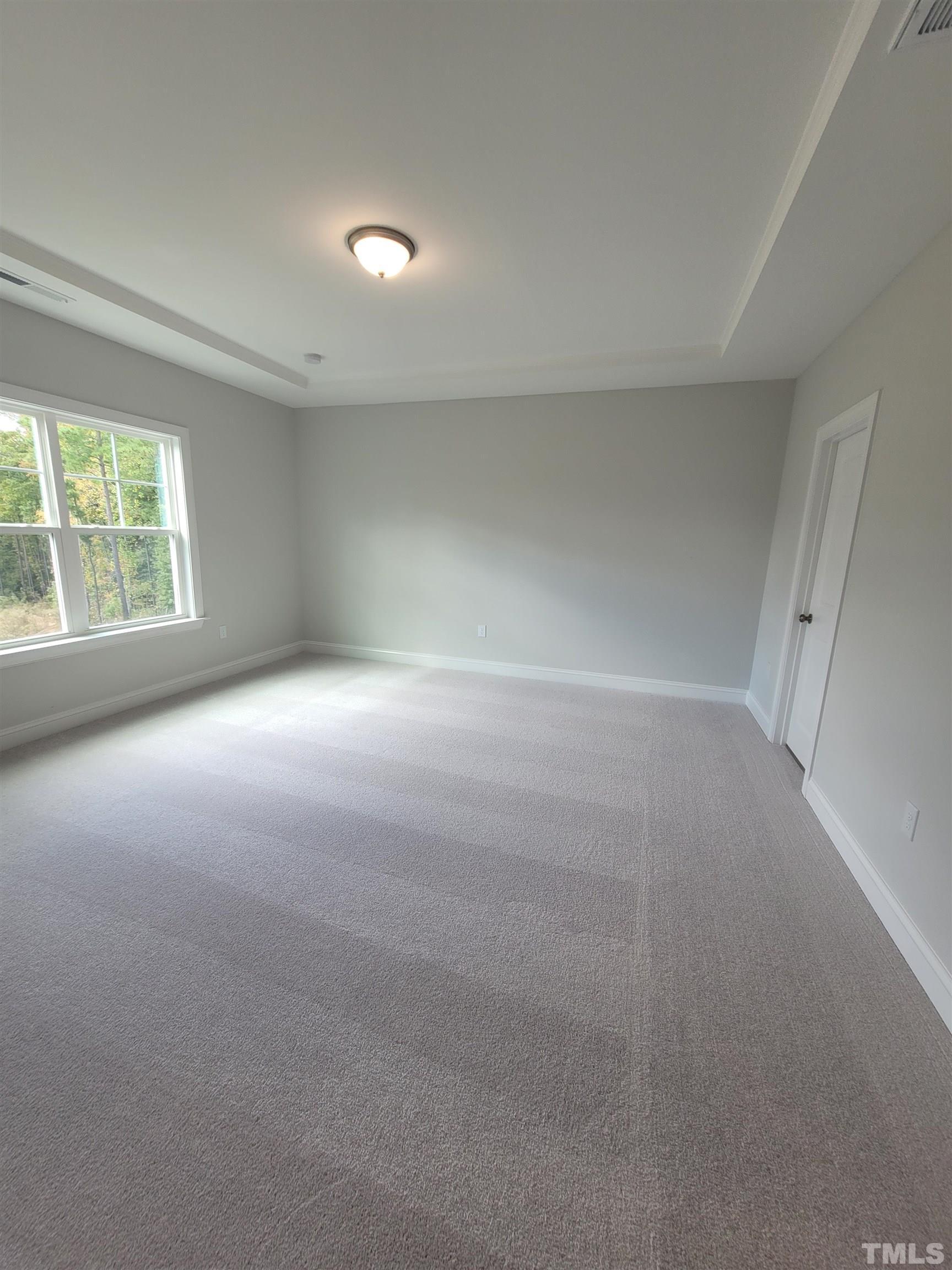 124 Trailing Bluff Way Garner, NC 27529 - Photo 17 of 21 an empty room with windows