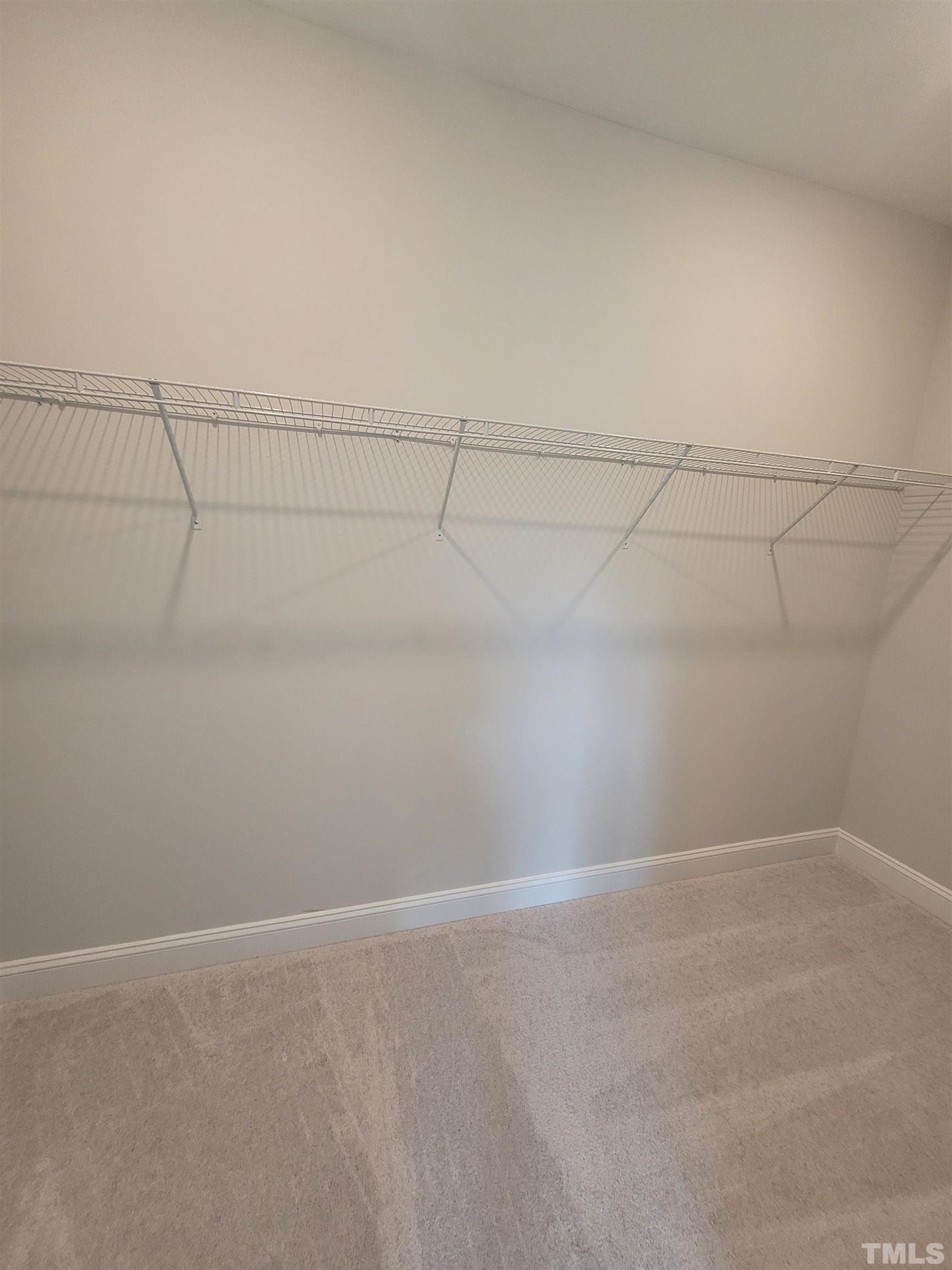 124 Trailing Bluff Way Garner, NC 27529 - Photo 18 of 21 a view of a room with racks on the wall