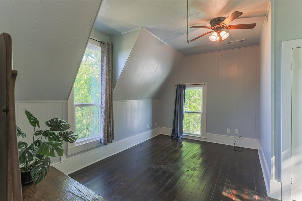 453 East Marshall Street Van Alstyne, TX 75495 - Photo 19 of 30 a view of an empty room with window and wooden floor