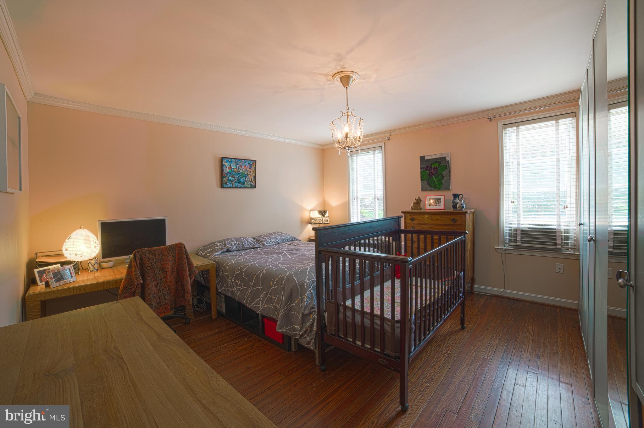 4535 Keswick Road Baltimore, MD 21210 - Photo 18 of 30 a bedroom with bed and a chandelier