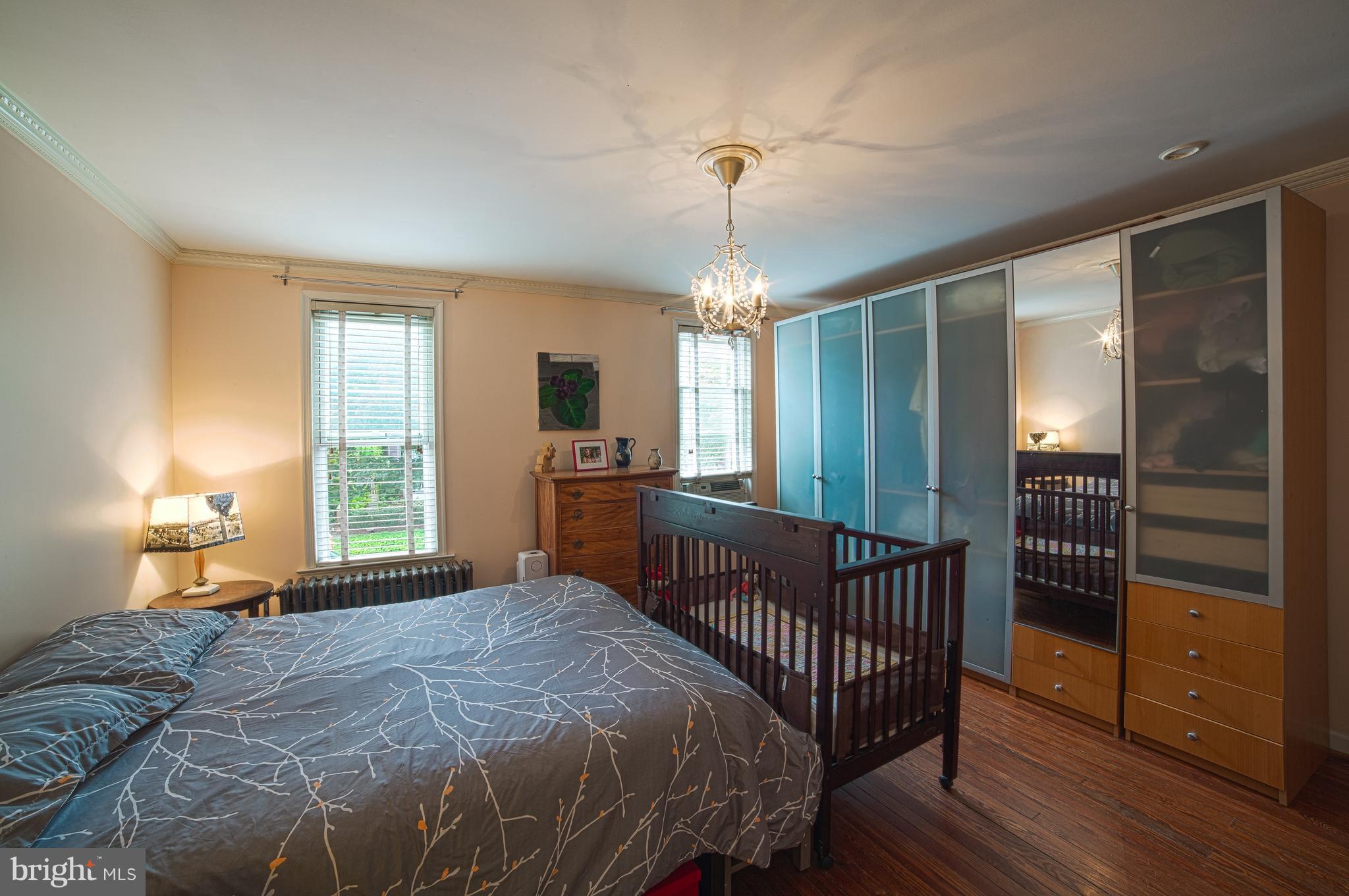 4535 Keswick Road Baltimore, MD 21210 - Photo 19 of 30 a bedroom with a bed and wooden floor