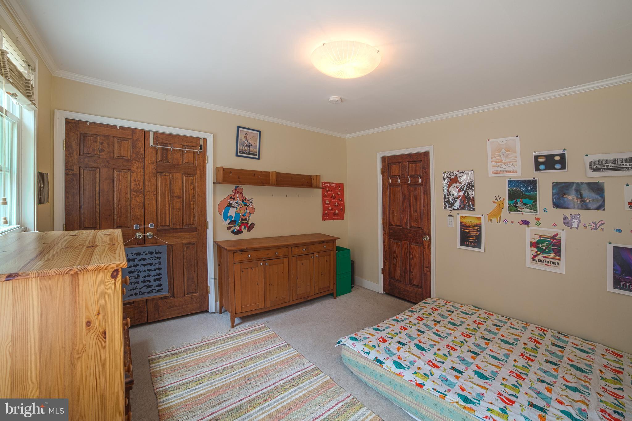 4535 Keswick Road Baltimore, MD 21210 - Photo 22 of 30 a bedroom with a bed and a dresser