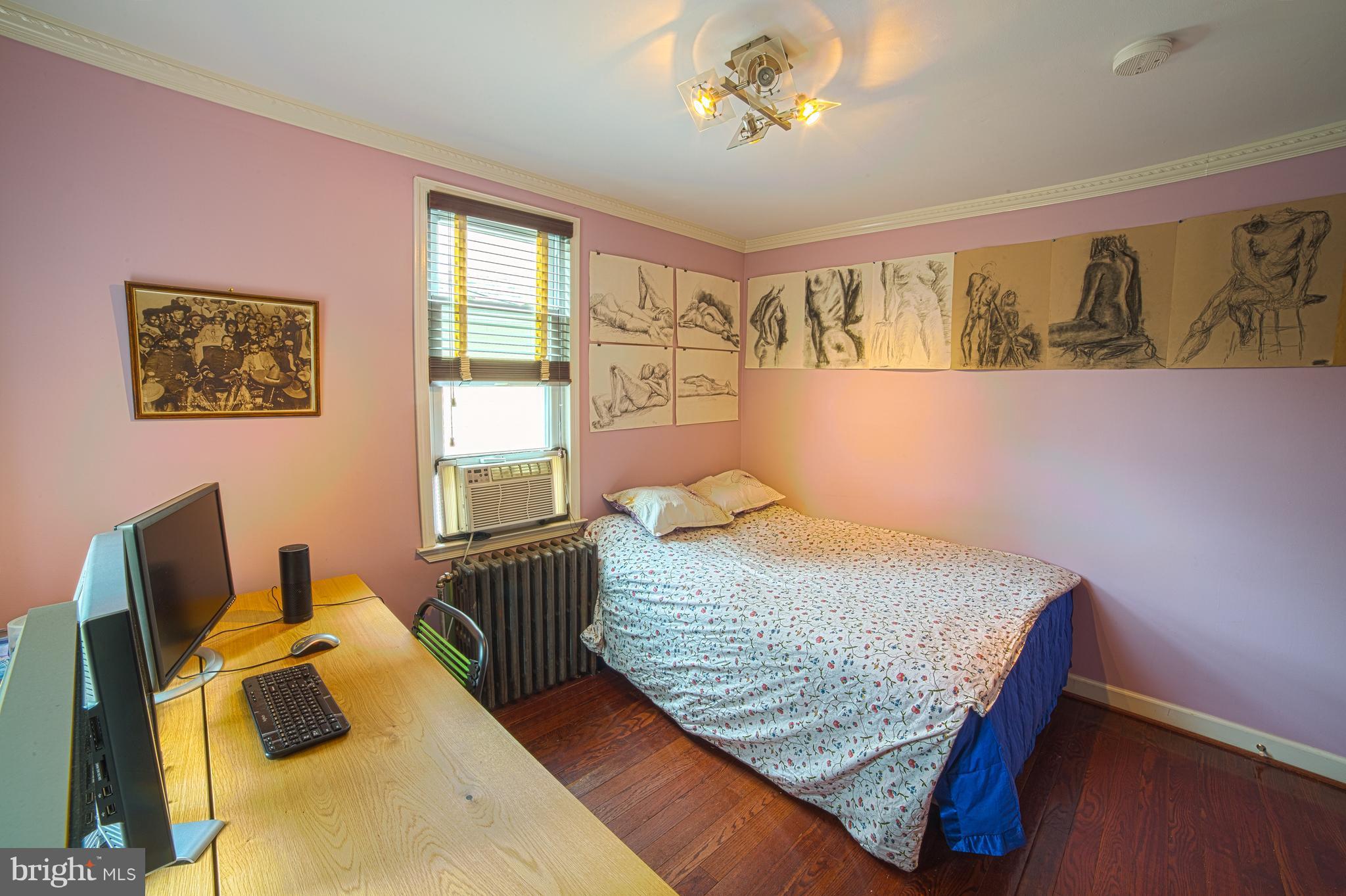 4535 Keswick Road Baltimore, MD 21210 - Photo 24 of 30 a bedroom with a bed and wooden floor