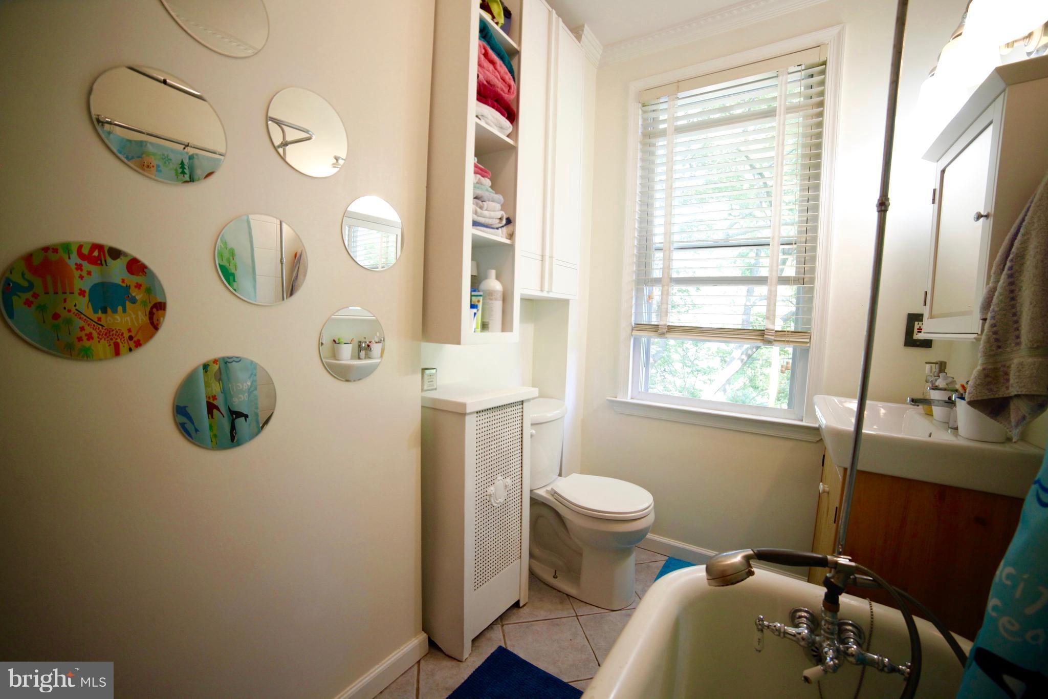 4535 Keswick Road Baltimore, MD 21210 - Photo 26 of 30 a bathroom with a sink mirror vanity and toilet