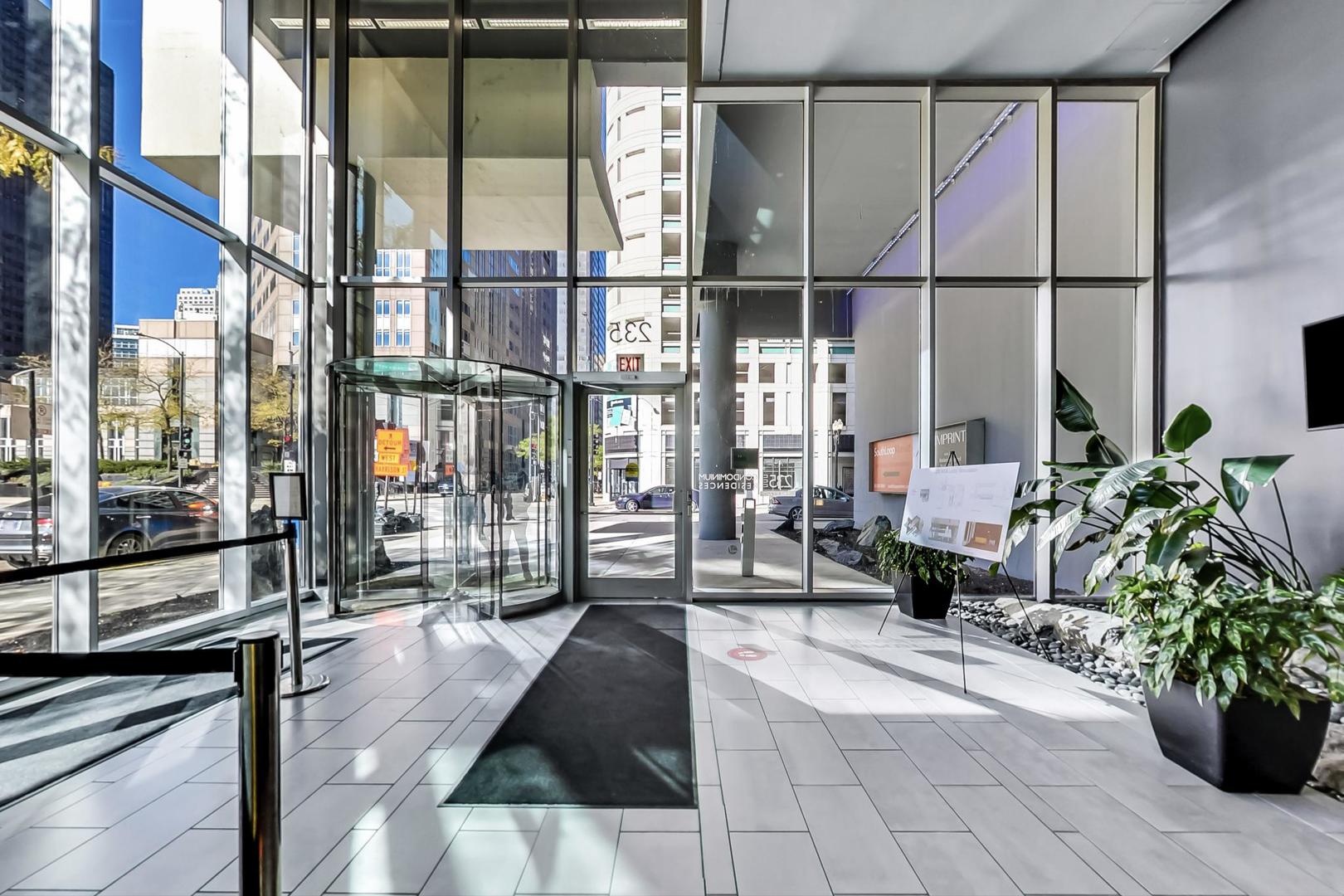 235 West Van Buren Street, Unit 1517 Chicago, IL 60607 - Photo 12 of 15 a lobby with furniture and floor to ceiling window