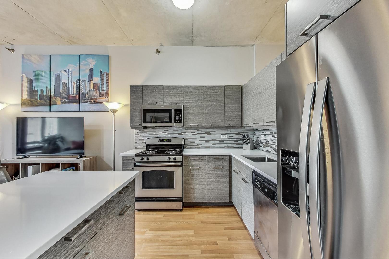 235 West Van Buren Street, Unit 1517 Chicago, IL 60607 - Photo 2 of 15 a kitchen with a stove top oven and refrigerator