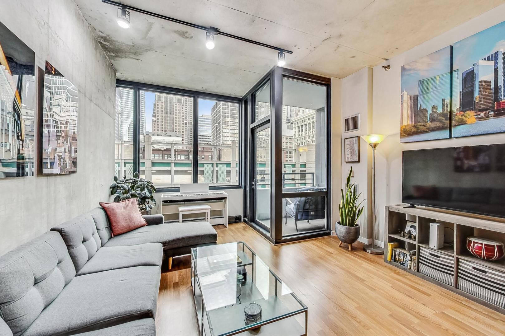 235 West Van Buren Street, Unit 1517 Chicago, IL 60607 - Photo 5 of 15 a living room with furniture and a flat screen tv