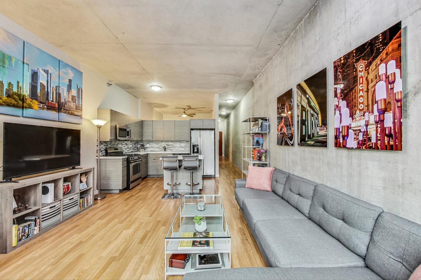 235 West Van Buren Street, Unit 1517 Chicago, IL 60607 - Photo 6 of 15 a living room with stainless steel appliances furniture and a flat screen tv