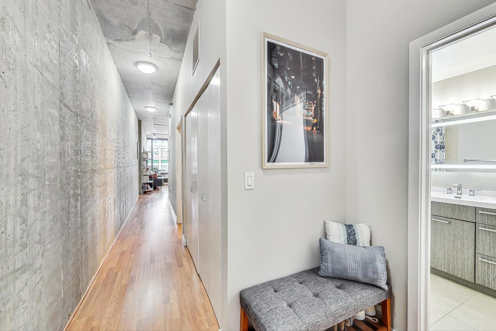 235 West Van Buren Street, Unit 1517 Chicago, IL 60607 - Photo 7 of 15 a hallway with furniture and wooden floor