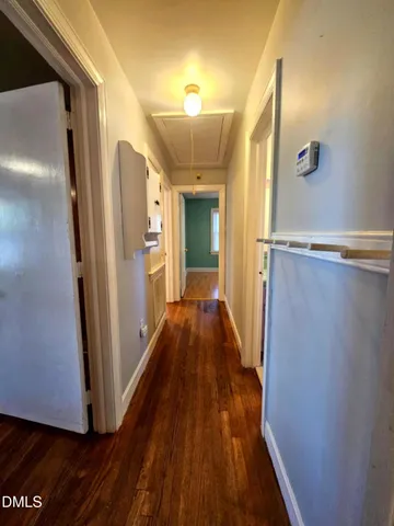 a view of a room with wooden floor and fan