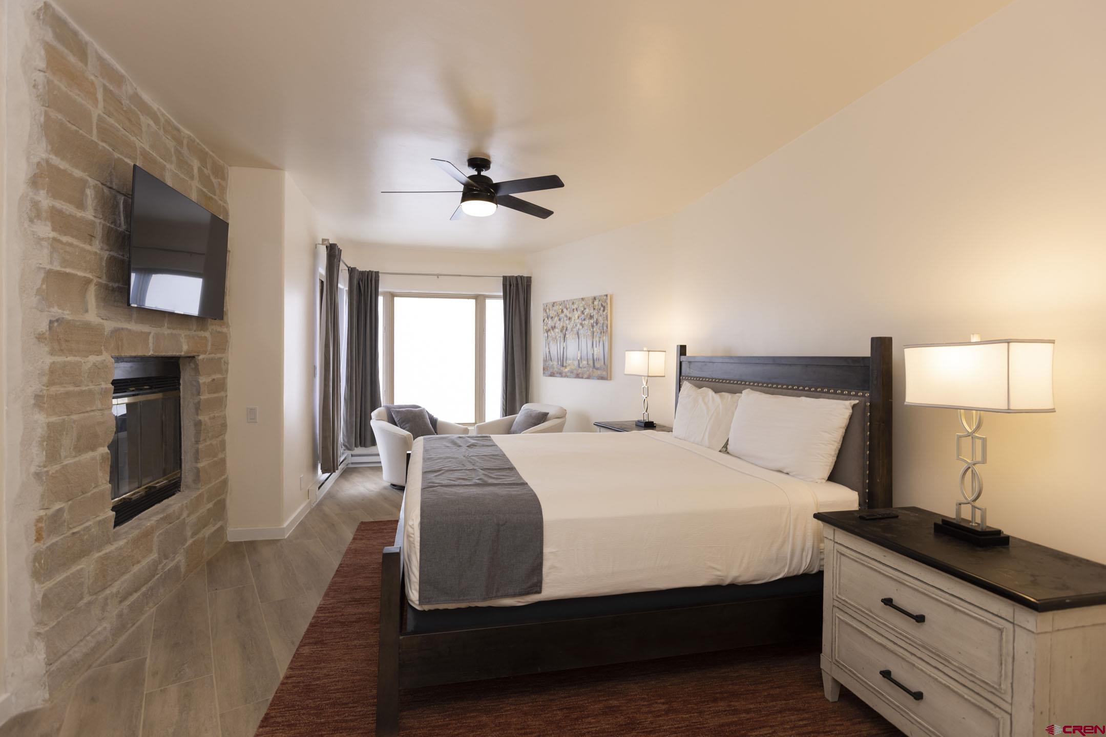 117 Needles Way, Unit 720 Durango, CO 81301 - Photo 16 of 33 a bedroom with a bed and a flat screen tv