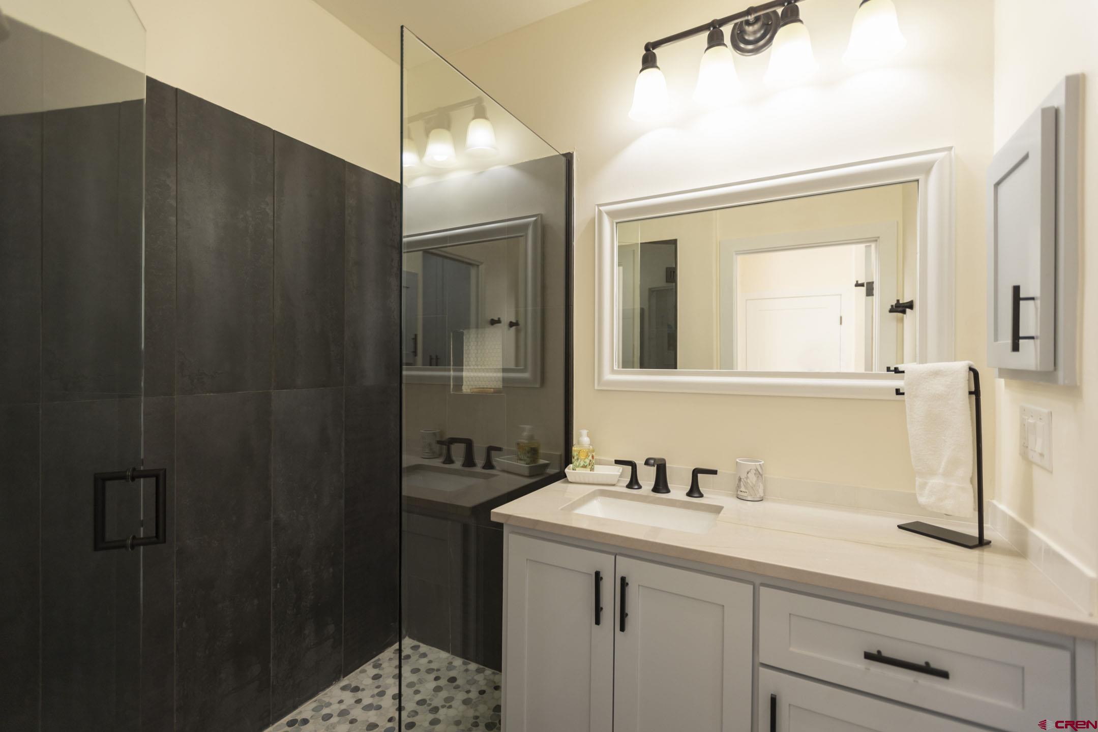 117 Needles Way, Unit 720 Durango, CO 81301 - Photo 18 of 33 a bathroom with a sink and mirror