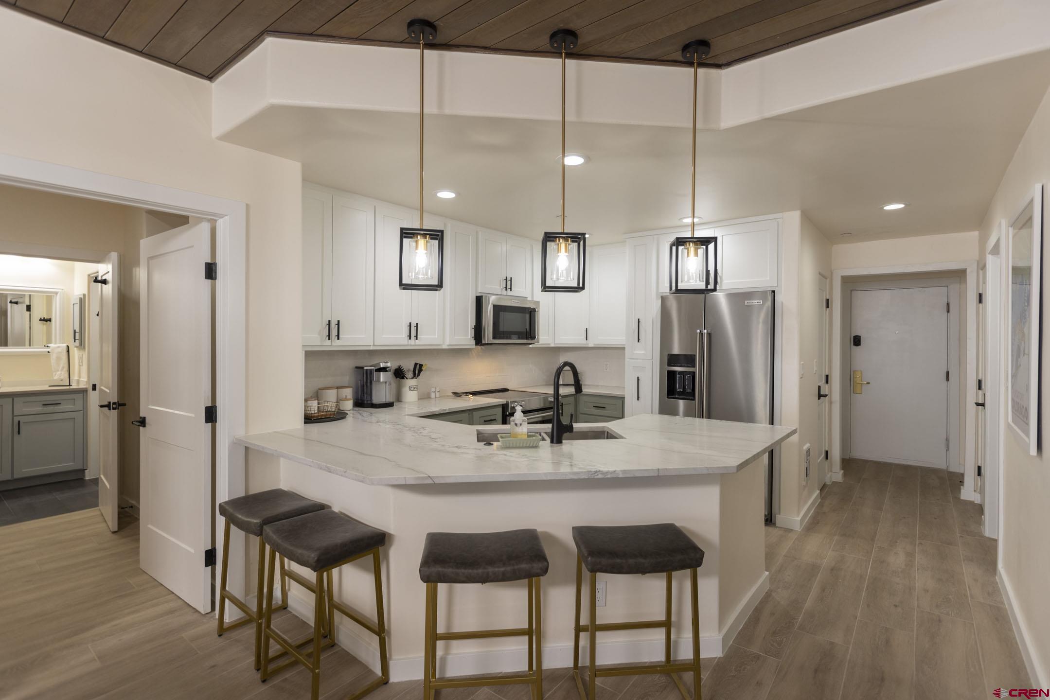117 Needles Way, Unit 720 Durango, CO 81301 - Photo 3 of 33 a view of a dining room and livingroom with furniture wooden floor