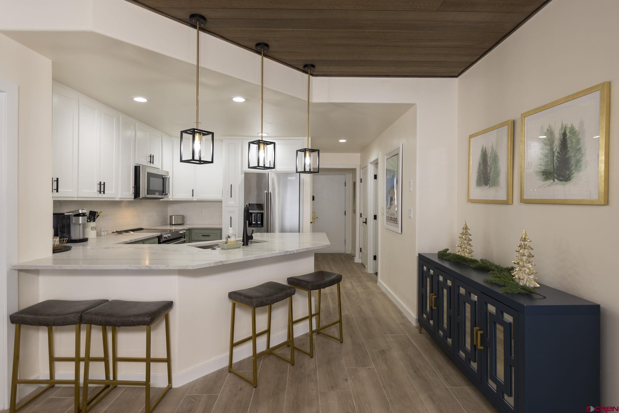 117 Needles Way, Unit 720 Durango, CO 81301 - Photo 5 of 33 a large kitchen with a large counter top appliances and cabinets