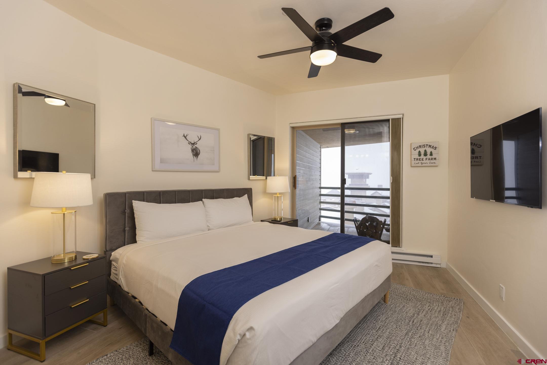 117 Needles Way, Unit 720 Durango, CO 81301 - Photo 10 of 33 a bedroom with a large bed and a tv