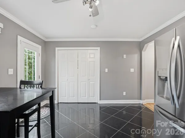 a empty room with a window and hallway