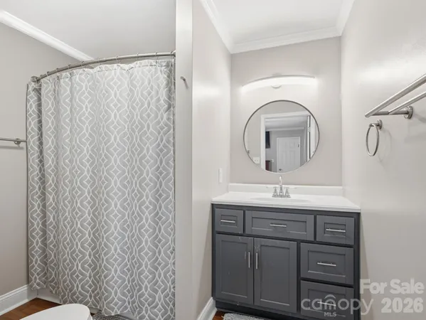 a bathroom with a granite countertop sink a toilet and a mirror
