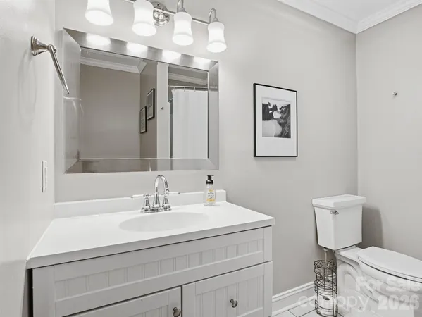 a bathroom with a sink toilet and a mirror