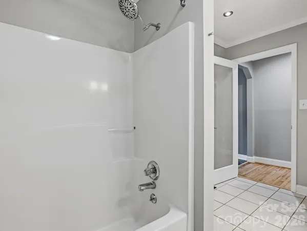a bathroom with a bathtub and shower