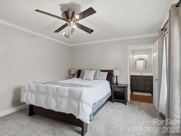 a bedroom with a bed and ceiling fan