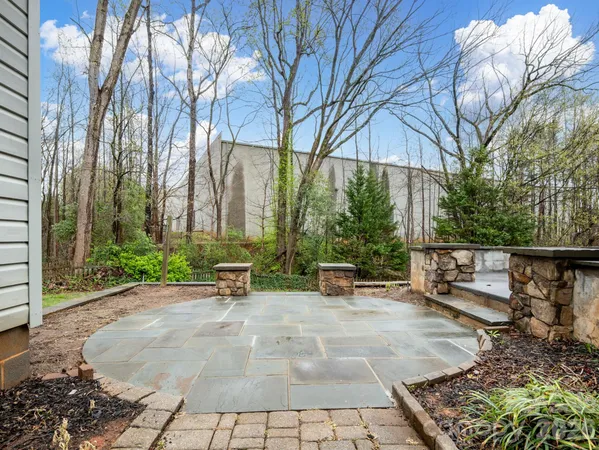 a view of a bench sitting in a backyard of a house